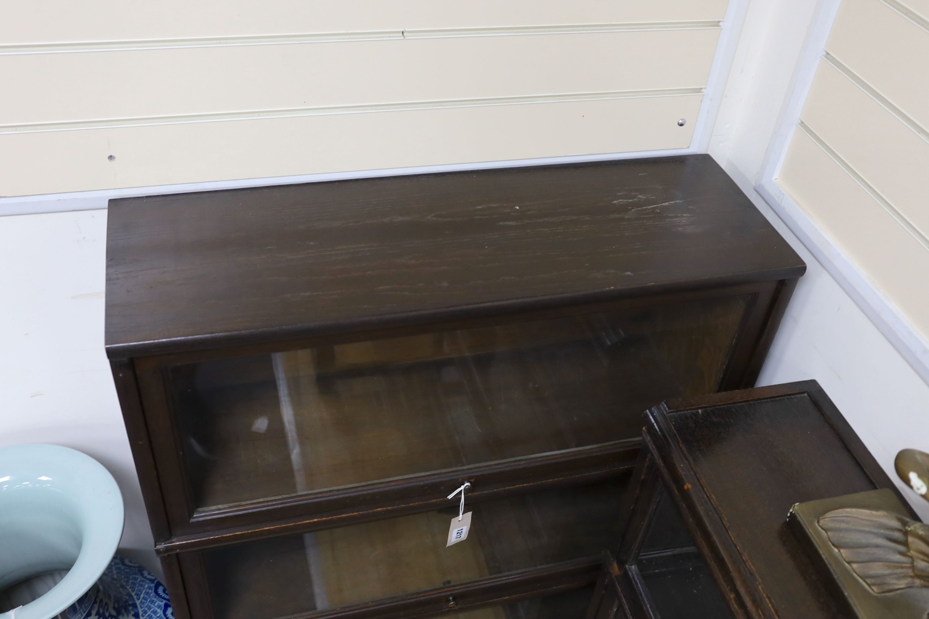 A Globe Wernicke oak four section glazed bookcase, length 87cm, depth 28cm, height 132cm